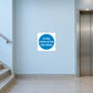Safety sign sticker, white square with blue circle: 'In the event of fire use stairs'