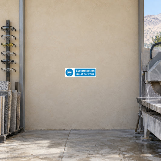 Safety sign sticker with blue border reading 'Eye protection must be worn'