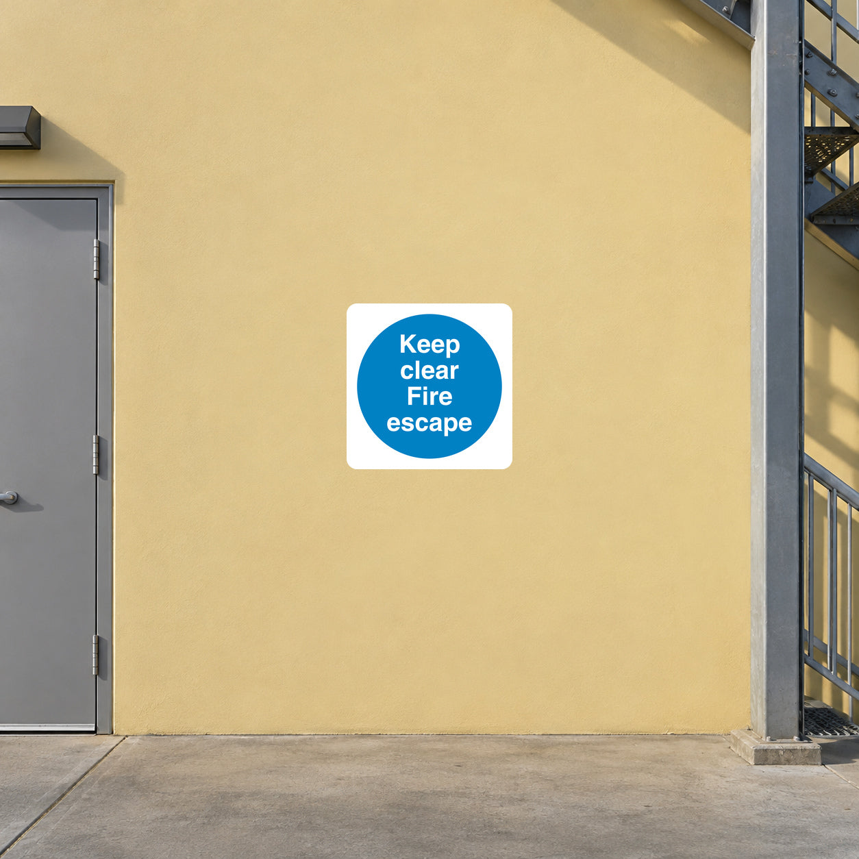 Safety sign sticker: blue 'Keep clear Fire escape' text