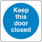 Safety sign sticker with "Keep this door closed" message in a blue circle