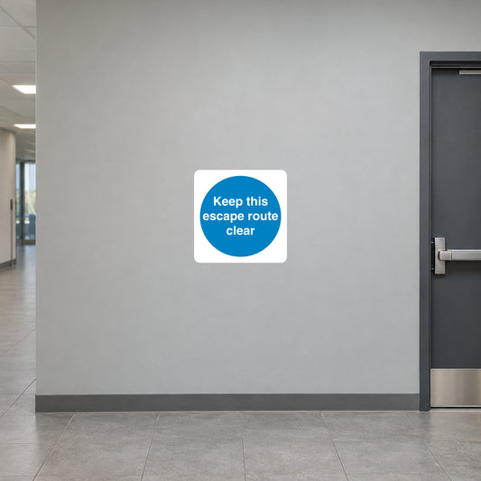 Safety sign sticker: white square with blue circle reading “Keep this escape route clear”