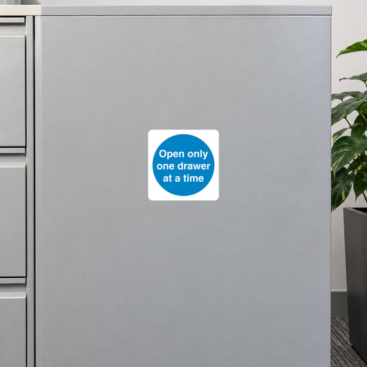 Safety sign sticker: blue circle with 'Open only one drawer at a time' text.