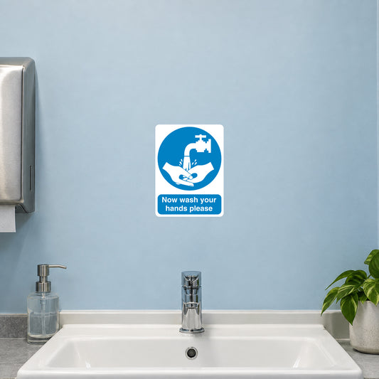 Safety Sign Sticker applied in a smooth pale blue washroom wall above a workplace handwash basin, tap below y85 and towel dispenser extreme left