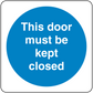 Safety sign sticker with blue circle text: 'This door must be kept closed'.