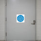 Safety sign sticker with blue text: door must remain unlocked when premises are occupied
