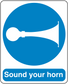 Safety sign sticker with blue circle, white horn icon, and 'Sound your horn' text.