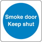 Safety sign sticker with blue circle and white text: "Smoke door Keep shut"