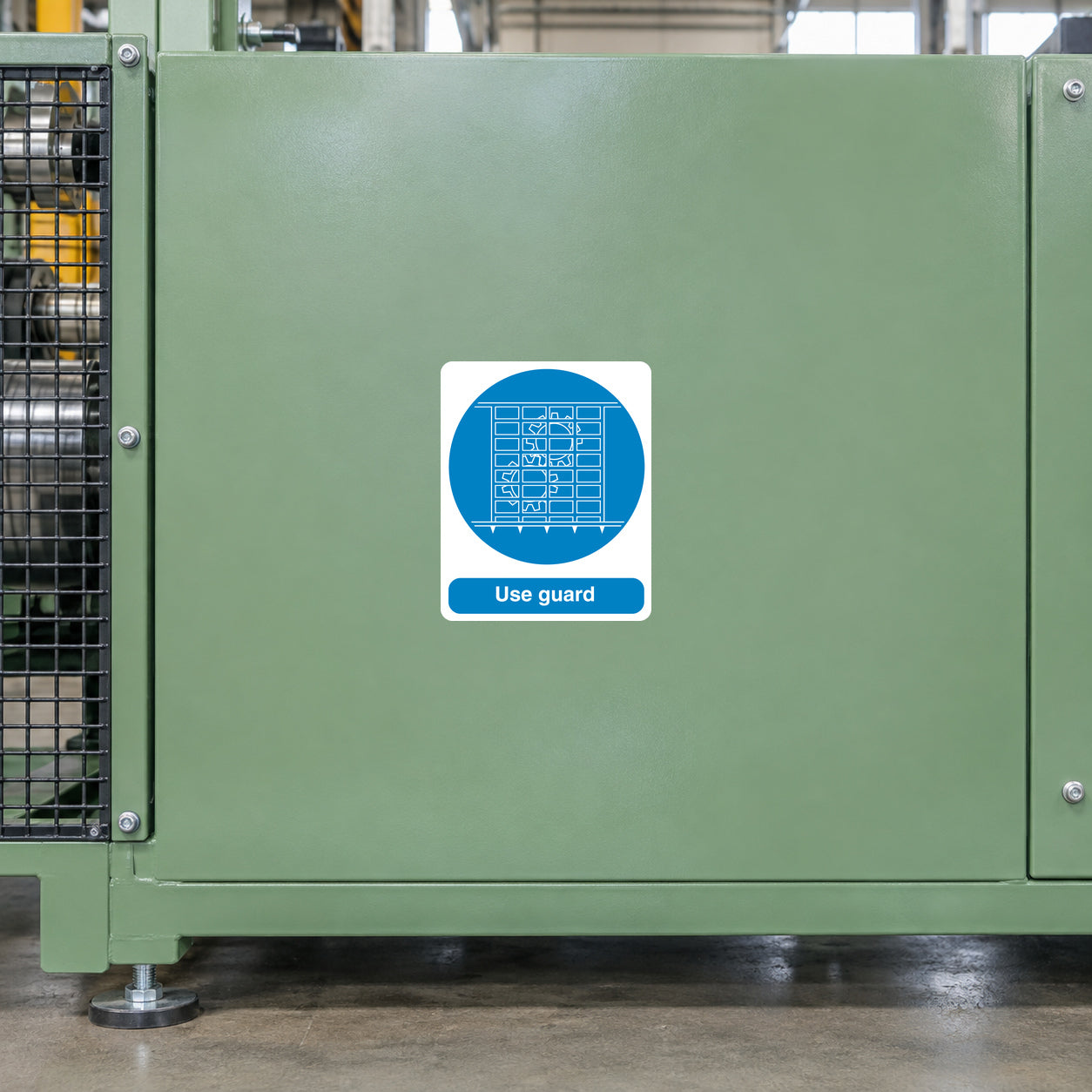 Safety sign sticker with white border, blue circle graphic, and “Use guard” text