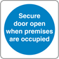 Safety sign sticker with blue circle text: "Secure door open when premises are occupied"