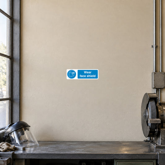Blue safety sign sticker reading "Wear face shield"