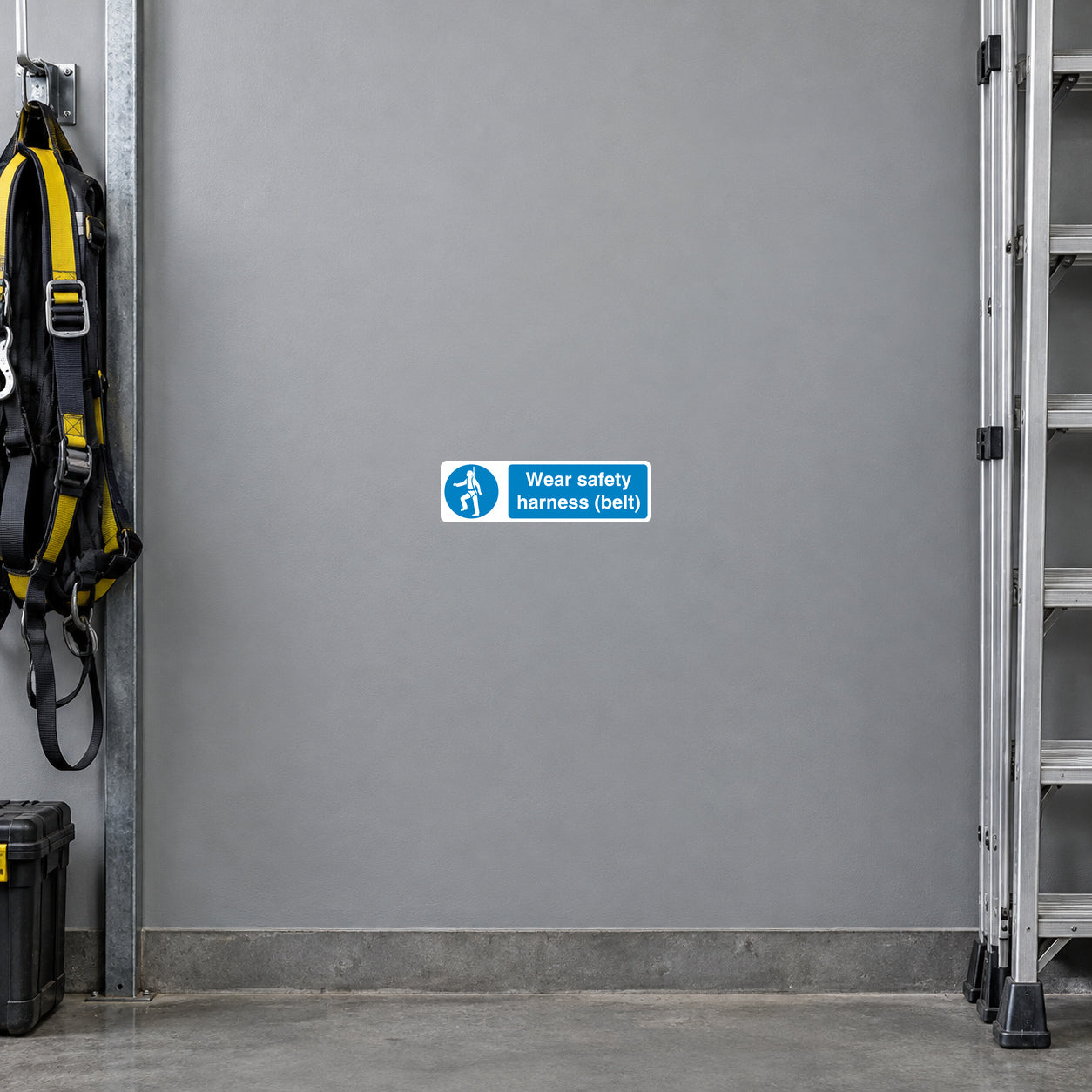 Blue safety sign sticker with white text: “Wear safety harness (belt!)” and icon