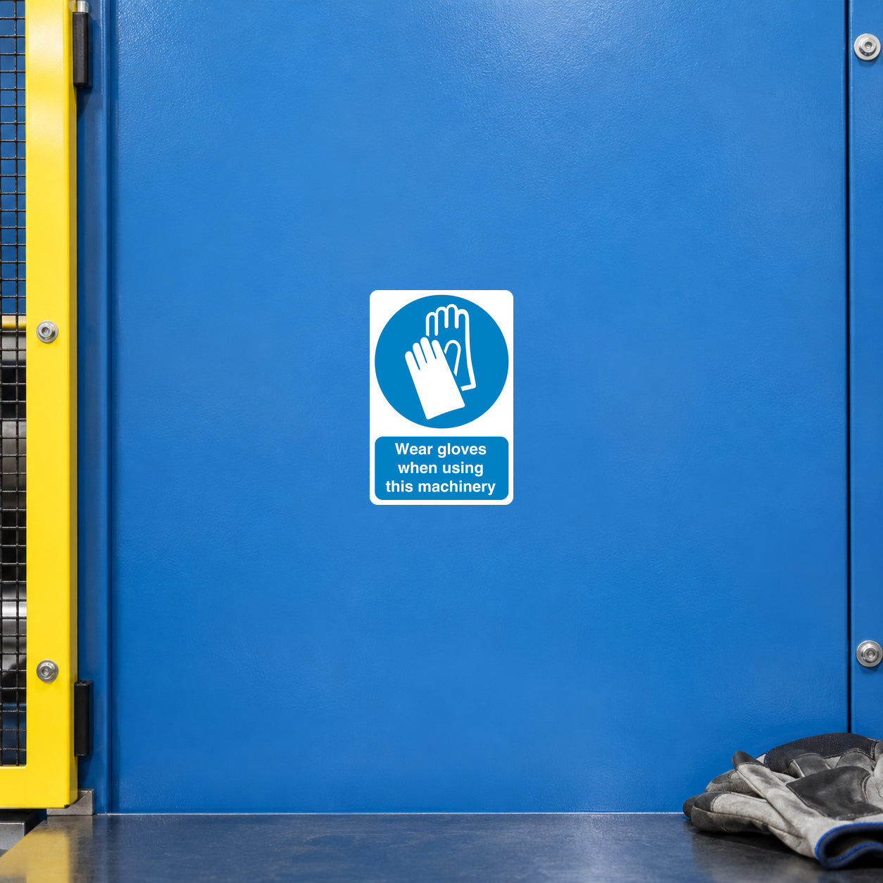 Safety sign sticker, white square: blue glove icon and text 'Wear gloves when using this machinery'