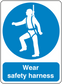 Safety sign sticker: blue round harness-wearing worker icon with 'Wear safety harness' text
