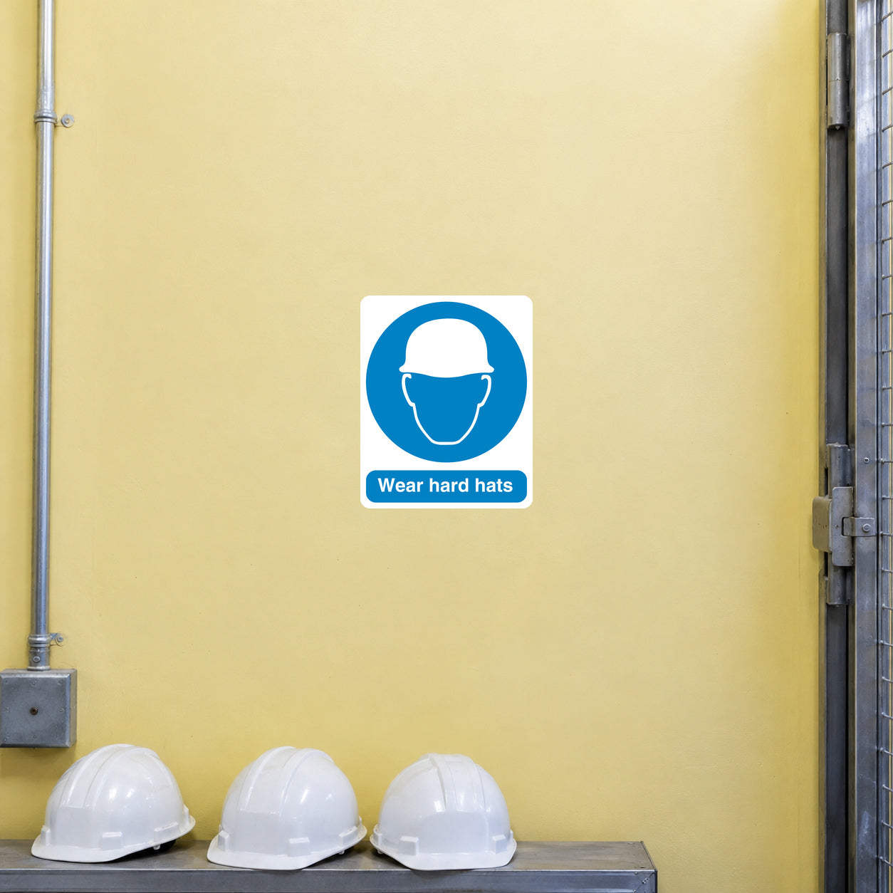Safety sign sticker with blue hard-hat icon and Wear hard hats text