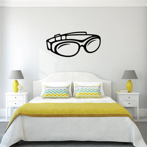 Motorcycle goggles decal in black outline, rounded lenses and strap