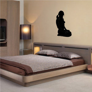 Black seated woman with pigtails silhouette wall decal, seated pose