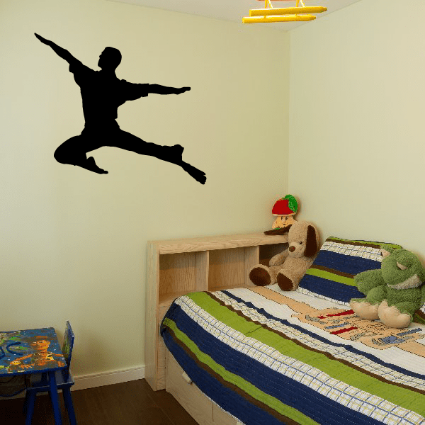 Skateboarding wall decal with black silhouette of a skateboarder mid-trick