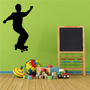 Skateboarding wall decal: black skateboarder silhouette in mid-ride pose