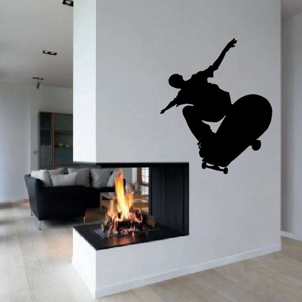 Skateboarder wall decal in black vinyl silhouette with skateboard mid-trick