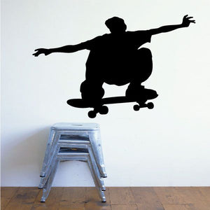 Skateboarding wall decal: black skateboarder silhouette in mid-trick