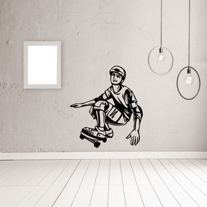 Skateboarding wall decal of black-and-white cartoon skater kneeling beside skateboard