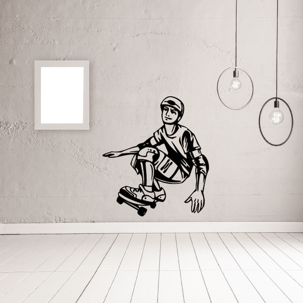 Skateboarding wall decal of black-and-white cartoon skater kneeling beside skateboard