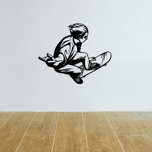 Skateboarding wall decal of a black silhouette skateboarder crouching with board