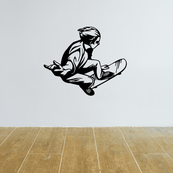 Skateboarding wall decal of a black silhouette skateboarder crouching with board
