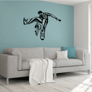 Skateboarding wall decal: black skateboarder silhouette midair on a wall.