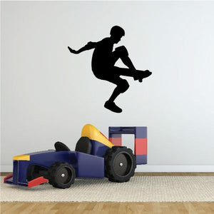 Skateboarding vinyl wall decal with black silhouette skateboarder mid-trick