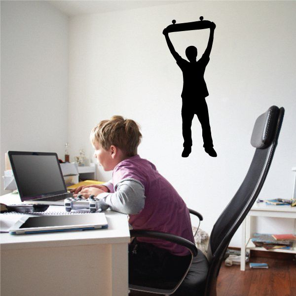 Black skateboarder silhouette wall decal with arms raised and skateboard shape