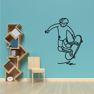 Skateboarder wall decal with black outline doing a tail grab on a skateboard