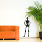 Skeleton hand-on-hips wall decal with black standing skeleton figure