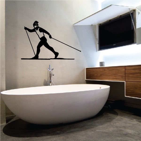 Skiing vinyl wall decal with black skier silhouette holding poles