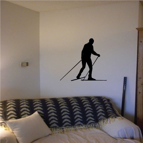 Skier vinyl wall decal with black silhouette and ski poles