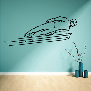 Skiing wall decal with black skier silhouette and skis