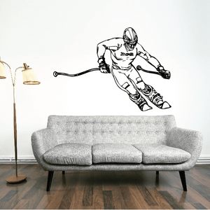 Skiing wall vinyl decal featuring a black outline skier in mid-slide