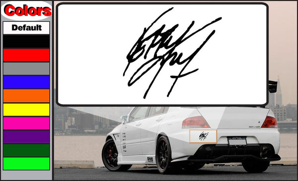 Black signature-style decal on white rectangular backing