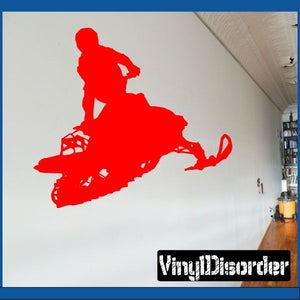 Red snowmobile jumping decal with rider silhouette, bold graphic