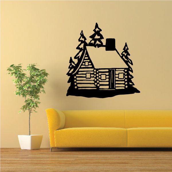 Log cabin wall decal with snowy roof and pine trees, black silhouette