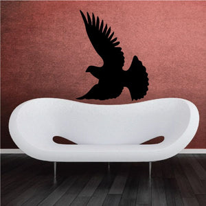 Soaring dove wall decal, black bird silhouette over white oval shape