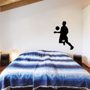 Soccer wall decal: black player silhouette kicking a ball