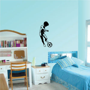 Soccer wall decal featuring a black soccer player silhouette kicking a ball