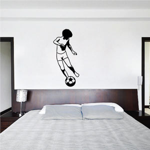 Soccer wall vinyl decal of black silhouette player kicking soccer ball