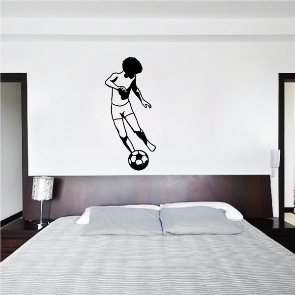 Soccer wall vinyl decal of black silhouette player kicking soccer ball