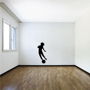 Soccer wall decal of black soccer player kicking a ball