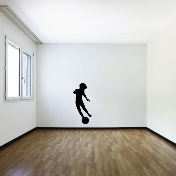 Soccer wall decal of black soccer player kicking a ball