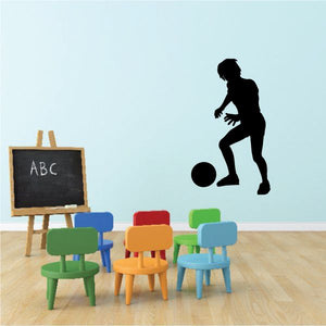 Soccer wall decal vinyl sticker of a child kneeling to play a soccer ball