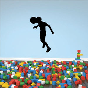 Soccer wall decal of black soccer player silhouette mid-kick