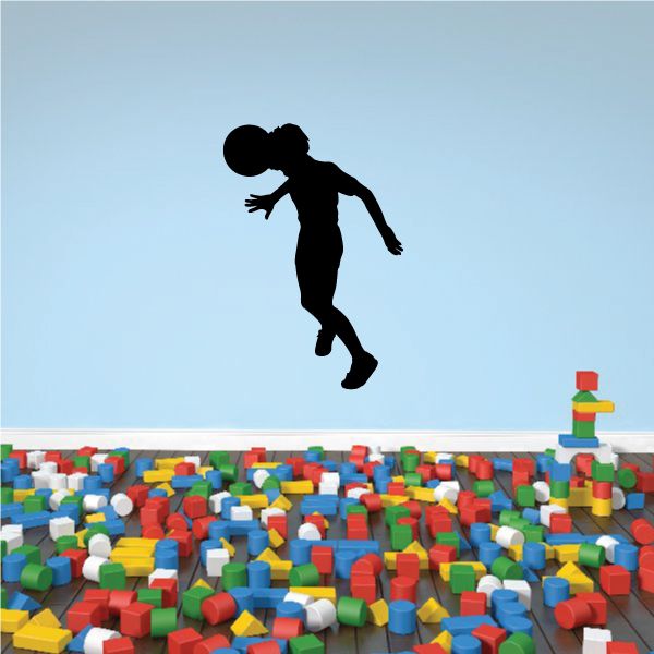 Soccer wall decal of black soccer player silhouette mid-kick